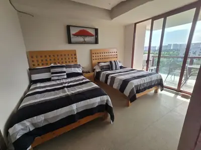 Cama o camas de una habitación en Precioso departamento en Acapulco Diamante