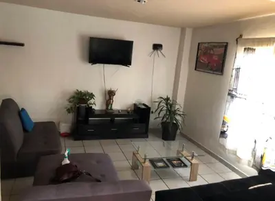 Una televisión o centro de entretenimiento en Departamento con Terraza LOBO