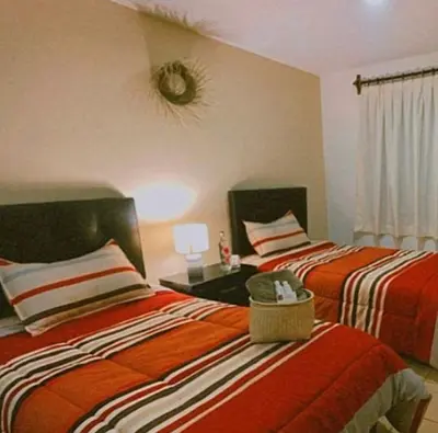 Cama o camas de una habitación en Casa Amapolas Oaxaca
