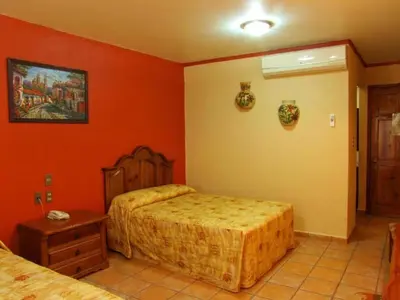 Cama o camas de una habitación en Hotel Oaxaca Dorado
