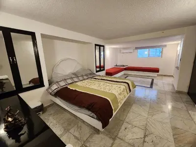 Cama o camas de una habitación en Secretos del Sol Acapulco villas a 5 minutosdel mar