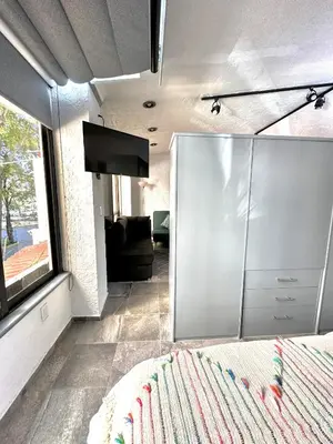 Una televisión o centro de entretenimiento en Departamento tipo LOFT cerca de hospital Angeles